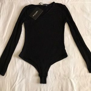 Black asymmetrical body suit.
